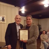 <p>Mayor/Supervisor Ron Belmont, left, declared Saturday Art Troilo Jr. Day in Harrison for his 30 years of service coaching Husky football taams and Little League baseball. Here, Troilo receives the proclamation during a celebratory dinner.</p>