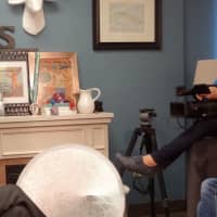 <p>Saray Stancic conducts an interview while Marcia Machado films</p>