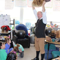 <p>Sam Ladley (aka “Colonial Man&quot;), dressed in colonial garb, presented a quick-paced lecture using dozens of artifacts to demonstrate his instruction, choosing from tables full of period tools, clothing, animal skins and weapons.</p>