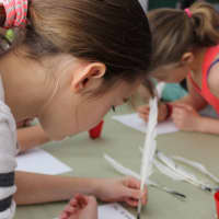 <p>The students experienced writing a letter using a quill pen and black ink.</p>