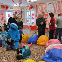 <p>Cookie Monster plays with children at the Valentine cookie competition in North Salem Sunday. More than 125 people turned out to the fundraiser for the North Salem Volunteer Ambulance Corps.</p>