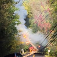 <p>The pole and wires are burning after an accident on Zaccheus Mead Lane at Fox Run Lane in Greenwich on Sunday morning.</p>