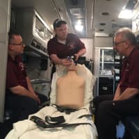 <p>From L: EMT Rich Sassi, QAQI Coordinator Jeff Ashdown and Allan Simmons demonstrate the corps&#x27; new CPAP device, which provides continuous positive airway pressure.</p>