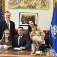 <p>Rep. John Frey, Natalie Whitton, Gov. Dan Malloy, Claudia Morgan and Anabella Morgan during the bill signing celebrating October as Dwarfism Awareness Month. </p>
