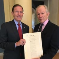 <p>U.S. Richard Blumenthal‏ gives a proclamation to Doug Walker of New Canaan, son of Brig. Gen. Kenneth N. Walker, who was lost on the San Antontio Rose in World War II and is still missing in action.</p>