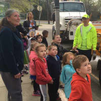 <p>Schoolchildren from James A. Garfield Childhood Learning Center watch a demonstration by the DPW</p>