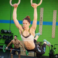 <p>Ramos performs a muscle-up on the rings at Great White CrossFit in Hackensack.</p>