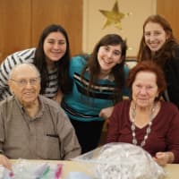 <p>Residents of the Jewish Home in Rockleigh sort medical equipment with students from Maayanot Yeshiva High School in Teneck. </p>
