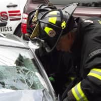 <p>Firefighters extricate the drivr,</p>
