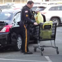 <p>Officer helps driver with packages.</p>