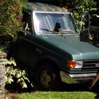 <p>The truck veered off the roadway, down an embankment and over a retaining wall.</p>