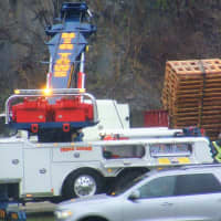<p>A wrecker was needed to offload the pallets and right the rig.</p>