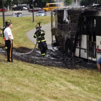 <p>Paramus Police and Fire Chief Kenneth Ehrenberg (left) eyes the totaled bus.</p>