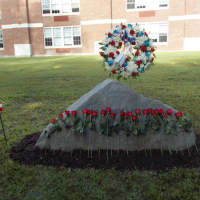 <p>Darien&#x27;s 9/11 Memorial adorned with roses and a wreath.</p>