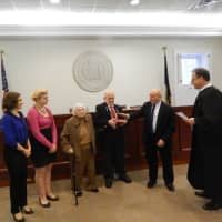 <p>Bedford Supervisor Chris Burdick, second from right, takes his oath of office. Burdick&#x27;s family members are pictured at left.</p>