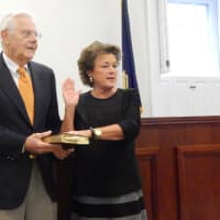 <p>Lee Roberts official returns to the Bedford Town Board as she is sworn in for a council seat. Roberts&#x27; husband to pictured at left.</p>