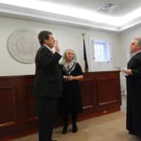 <p>Bedford Councilman Don Scott, left, takes his oath of office. Scott&#x27;s wife stand by his side.</p>