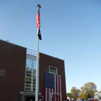 <p>A fireman&#x27;s helmet tops a flag pole in front of the Emerson Fire House. </p>