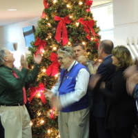 <p>County Executive Jim Tedesco of Paramus claps his hands as the tree is lit at One Bergen County Plaza. Also shown: Freeholders David Ganz, Fair Lawn, Steve Tanelli, North Arlington, County Clerk John Hogan, Northvale, and Tracey Zur, Franklin Lakes.</p>