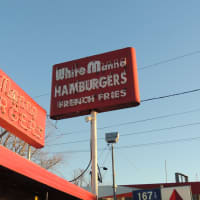 <p>The White Manna signpost on River Street in Hackensack is a welcoming beacon to its fans.</p>