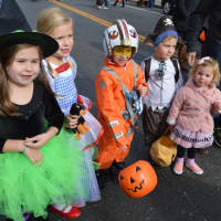<p>Kids decked out in costume hit Main Street in Ridgefield for trick-or-treating.</p>