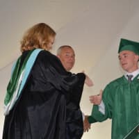 <p>A newly minted Webutuck High School graduate receives his diploma.</p>