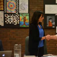 <p>Pam Harney shakes hands with District Clerk Carole LaColla after being sworn in for a trustee seat on Bedford Central&#x27;s school board.</p>