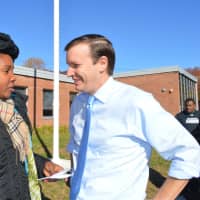 <p>U.S. Sen. Chris Murphy talks with voters outside Wilbur Cross School in Bridgeport on Tuesday.</p>