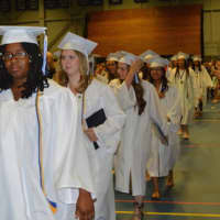 <p>Immaculate High graduates file out at the end of the Mass and commencement .</p>