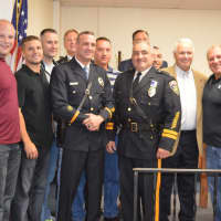 <p>Emerson Police Capt. Michael Mazzeo (center) with Chief Donald Rossi (third from right) and former Chief Peter Mazzeo (second from right), surrounded by law enforcement officials, family members and friends.</p>