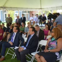 <p>Gov. Dannel Malloy and Bridgeport Mayor Joe Ganim, center in suits, listen to the presentations at Crescent Crossings Tuesday.</p>