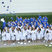 <p>The Class of 2016 from Immaculate High School in Danbury celebrates after commencement exercises on Wednesday evening.</p>