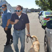<p>Bridgeport Mayor Joe Ganim spends quality time with his new buddy, Duke, who had just relieved himself on a car tire.</p>