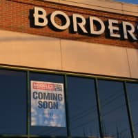 <p>Signage announcing the impending arrival of Modell&#x27;s Sporting Goods to Mount Kisco is juxtaposed with the signage of its building&#x27;s old tenant, defunct bookstore chain Borders.</p>