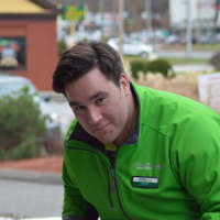 <p>An employee at GreenDrop in Brookfield collects household items for charity Friday.</p>