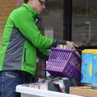 <p>GreenDrop General Manager Jason Coss collects household items for charity Friday.</p>
