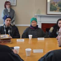 <p>Bridgeport Mayor Joe Ganim, right, speaks with translator Nick Khamarji as Farida Alfaawri, center, and her children look on.</p>