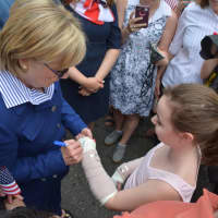 <p>Hillary Clinton autographs a girl&#x27;s cast prior to the start of New Castle&#x27;s 2016 Memorial Day parade.</p>