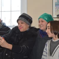 <p>Bridgeport City Council member Evette Brantley, second from left, takes a selfie with Syrian refugees Farida Alfaawri and her son Rayid at the International Institute of Connecticut.</p>