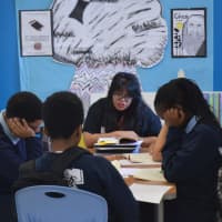 <p>Students at Great Oaks Charter School work in small groups to boost their reading and comprehension skills.</p>