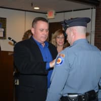 <p>Retired Paramus Police Sergeant Glenn Doughty. pins his son, Brian Doughty.</p>