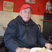 <p>A Jolly Nick&#x27;s customer enjoys his usual hot dog with sour kraut.</p>