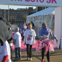 <p>Participants in the kids fun run cross the finish line before the start of the 2016 Vicki Soto 5K in Stratford.</p>