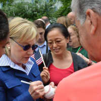<p>Hillary Clinton autographs a baseball while meeting community members prior to the start of New Castle&#x27;s 2016 Memorial Day parade.</p>