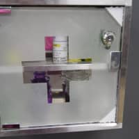 <p>A medicine cabinet is locked up against a wall.</p>