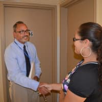 <p>New Bassick High School Principal Tomas Ramirez introduces himself to incoming freshman Milannie Moran outside her apartment in the Charles F. Greene Homes in Bridgeport.</p>