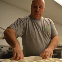 <p>Grisafe wraps his cheese before refrigeration.</p>