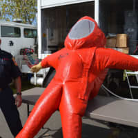 <p>Norwalk firefighter Mike Fratello explains an inflated Type A hazardous materials suit.</p>