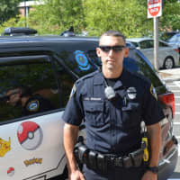 <p>Officer Kevan Taggart offers safety tips to Pokémon Go players in Darien Tuesday.</p>