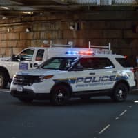 <p>An MTA police cruiser blocks off South Main Street in South Norwalk as crews inspect a railroad bridge hit by a dump truck.</p>